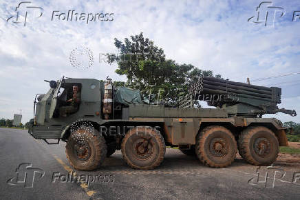 A Cambodian military personnel gestures from a BM-21 Grad multiple rocket launcher in Oddar Meanchey province