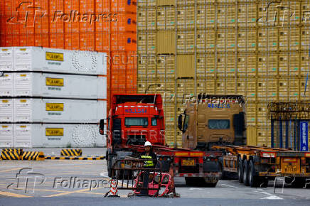 FILE PHOTO: Security personnel stands guard at an entrance to a container logistics centre at the Yantian port in Shenzhen, Guangdong province