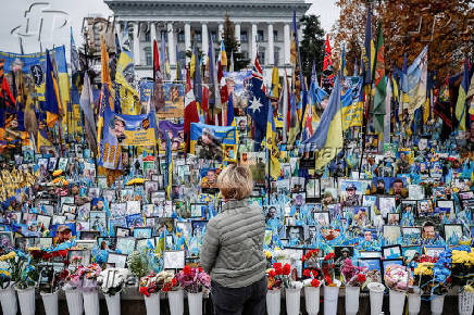Woman appears in front of the makeshift memorial to fallen Ukrainian defenders at Independence Square in Kyiv