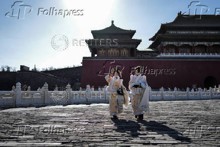 Tourists visit the Forbidden City in Beijing