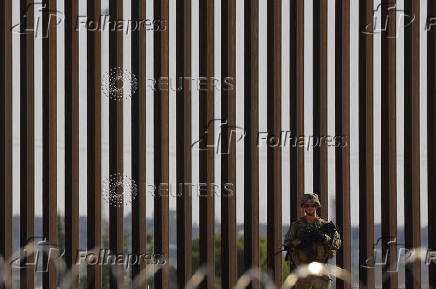 U.S. soldiers reinforce border wall with razor wire seen from Ciudad Juarez