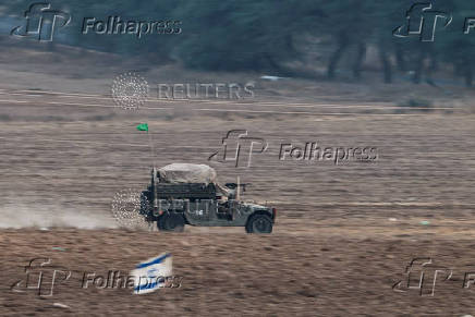 Israeli military vehicle maneuvers, near the Israel-Gaza border