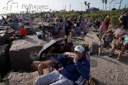 People wait to watch SpaceX's next-generation Starship spacecraft atop its Super Heavy booster launch