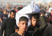 Palestinians receive aid from the U.S.-backed Gaza Humanitarian Foundation, in Khan Younis