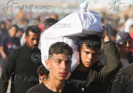 Palestinians receive aid from the U.S.-backed Gaza Humanitarian Foundation, in Khan Younis
