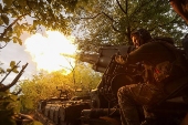 A serviceman of the Ukrainian Armed Forces fires a self-propelled gun toward Russian positions on a front line in Donetsk region