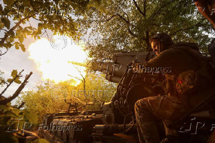 A serviceman of the Ukrainian Armed Forces fires a self-propelled gun toward Russian positions on a front line in Donetsk region