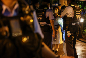 Student is stopped and searched on 36th anniversary of Beijing's Tiananmen Square crackdown on pro-democracy demonstrators in Hong Kong