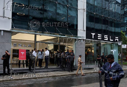 FILE PHOTO: People are seen outside the Tesla showroom ahead of its opening in Mumbai