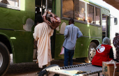 Displaced people leave the camp following a drone strike, in Ad-Damar