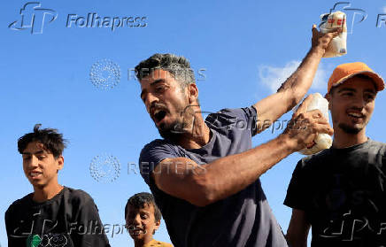 Palestinians seeking aid gather near an aid distribution site run by the U.S.-backed Gaza Humanitarian Foundation, in Rafah