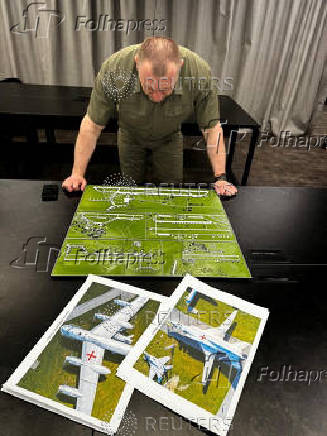 Head of the Ukraine's Security Service Maliuk looks at a map of an airfield in an unknown location in Ukraine