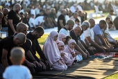 Israeli Muslims pray on the first day of the Muslim holiday of Eid al-Adha by the sea side of the Mediterranean, in Jaffa