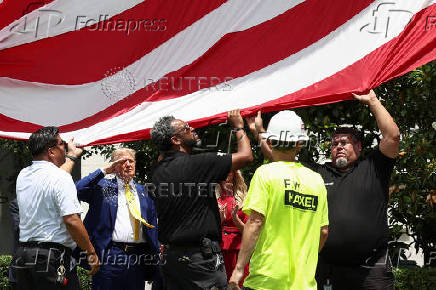 A U.S. flag is raised on a new flagpole installed on the South Lawn of the White House in Washington