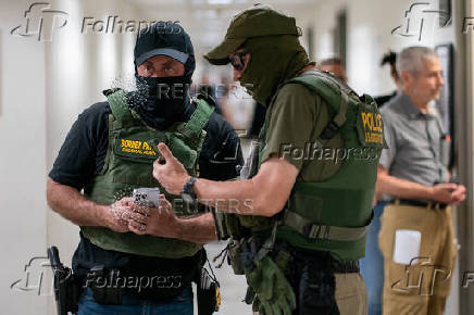 A migrant is detained by federal immigration officers at U.S. immigration court
