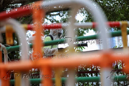 A worker sprays insecticide at a public housing estate following reports of imported cases of Chikungunya in Hong Kong