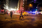 Security personnel react at an impact site following missile attack from Iran on Israel, in Tel Aviv