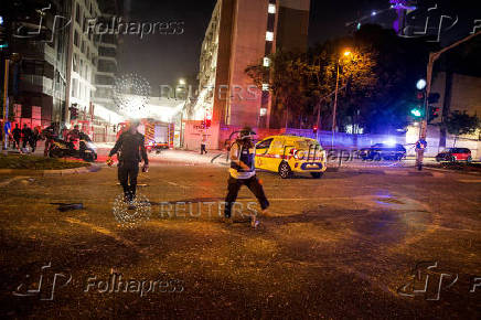 Security personnel react at an impact site following missile attack from Iran on Israel, in Tel Aviv