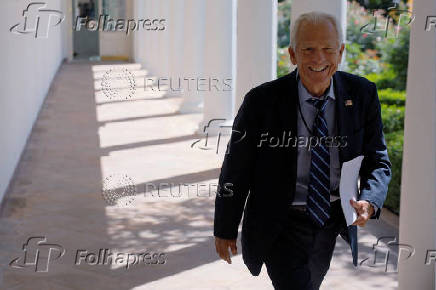 Trade advisor Navarro walks past news photographers at the White House in Washington