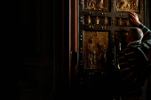 A faithful kisses as he touches the Holy Door in St. Peter's Basilica at the Vatican