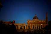 A man takes a selfie in front of St. Peter's Basilica in St. Peter's Square ahead of the conclave which will be held on May 7, at the Vatican