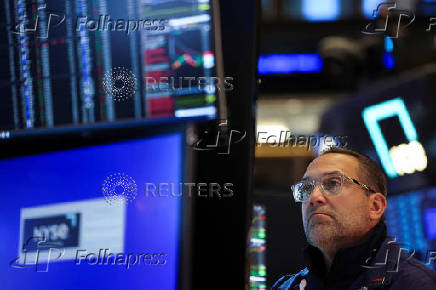 A trader works on the floor at the New York Stock Exchange (NYSE) in New York City