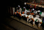FILE PHOTO: Miners take a break in a waiting area deep underground at Sibanye Gold's Masimthembe shaft in Westonaria