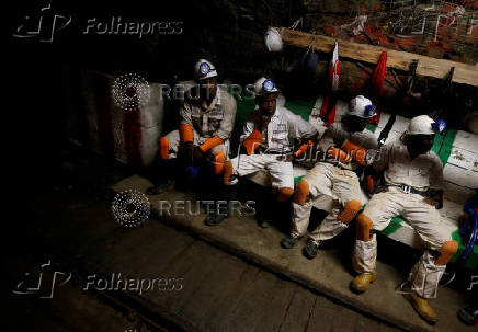 FILE PHOTO: Miners take a break in a waiting area deep underground at Sibanye Gold's Masimthembe shaft in Westonaria