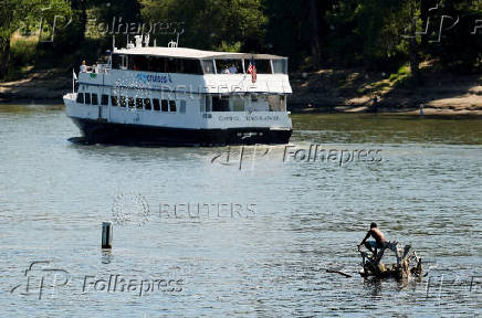 FILE PHOTO: A man stays cool during heat wave in Sacramento