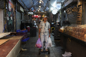 People shop in Jerusalem following an Israeli strike in Iran