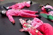 Activists stage a theatrical show during a protest against Israel and in support of Palestinians in Gaza, outside the U.S. embassy in Jakarta,