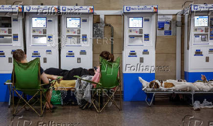 People take shelter inside a metro station during an air raid alert in Kyiv
