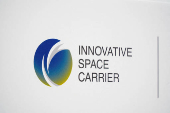 The logo of Innovative Space Carrier is displayed at a press conference in Yokohama