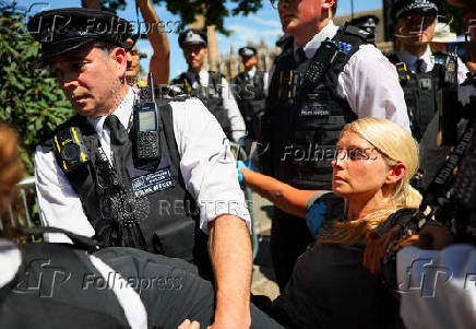 People gather in Parliament Square calling for the de-proscription of the Palestine Action group, in London