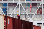 FILE PHOTO: A crew member works on a container ship which is docked at Yangshan Port outside of Shanghai