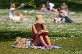 People enjoy the sunny weather in London