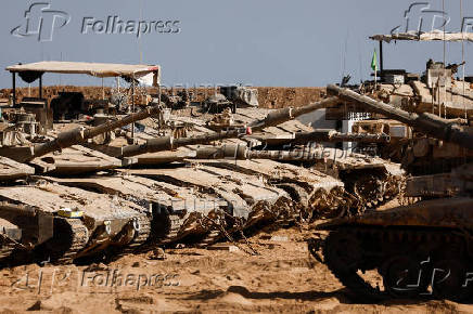Israeli military vehicles stand near the Israel-Gaza border, in Israel