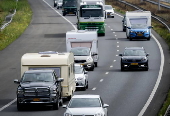 Vacationers have their vehicles checked at the border crossing with Belgium