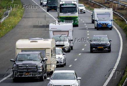 Vacationers have their vehicles checked at the border crossing with Belgium