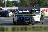 Police close off Alondra Boulevard due to a nearby protest against federal immigration sweeps, in Compton