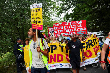 Anti-racism protesters attend a counter protest, on the day of an anti-immigration demonstrations outside the Bell Hotel in Epping