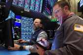 Traders work on the floor at the New York Stock Exchange, in New York City