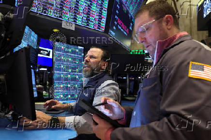 Traders work on the floor at the New York Stock Exchange, in New York City