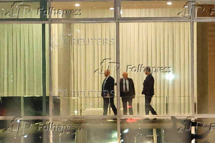 Brazil's Supreme Court Judge Alexandre de Moraes stands next to Brazil's President Luiz Inacio Lula da Silva and Brazil's Prosecutor General Paulo Gonet after a dinner at the Alvorada Palace in Brasilia
