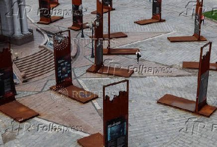 A woman walks past an installation at the Independence Square in central Kyiv
