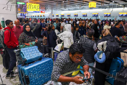 FILE PHOTO: Travellers at Heathrow Airport amid cyberattack disruptions, in Greater London