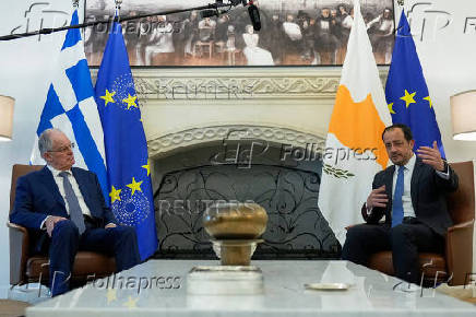 Cyprus' President Nikos Christodoulides and Greek President Constantine Tassoulas talk during a meeting at the Presidential Palace in Nicosia