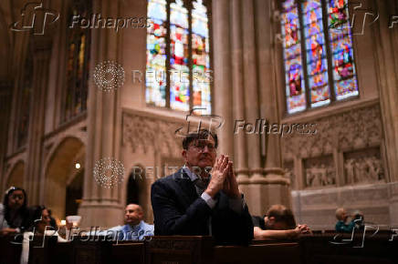 A person prays inside St. Patrick?s Cathedral after the news that Cardinal Robert Prevost of the United States was elected the new pope, in New York City