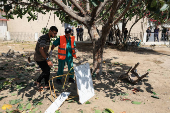 Palestinians inspect the damage, after the Al-Ahli Arab Hospital was partially damaged in Israeli airstrike, in Gaza City