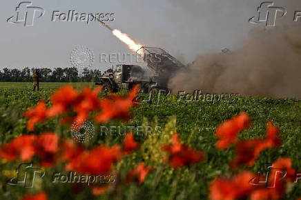 Ukrainian servicemen fire a multiple rocket launcher towards Russian troops on a front line in Zaporizhzhia region